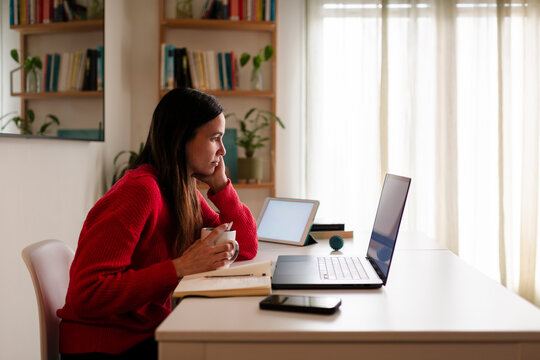 Student attending online class with laptop