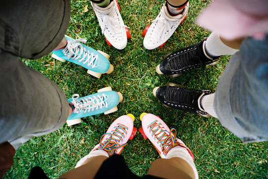 Film Photo of Group of Friends in Colorful Roller Skates on Grass