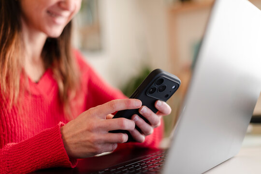 Close-Up of Smiling Woman Texting on Smartphone