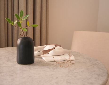 Reading glasses, e-reader, headphones on a marble tabletop