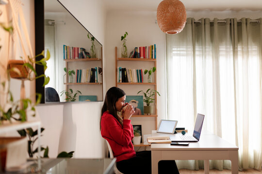 Woman Taking Quiet Coffee Break at Home Office