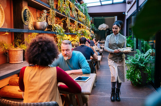 People enjoying themselves in a green restaurant bar