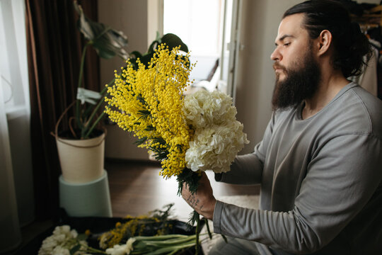 Profile portrait of man creating flower bouquet