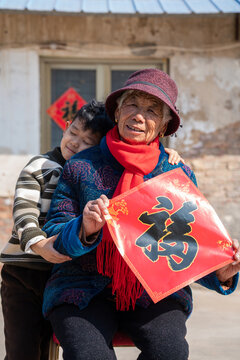 Grandmother and grandson with Fu characters