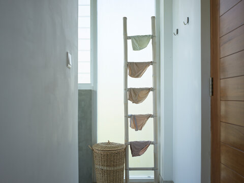 Laundry Drying on a Ladder in a Hotel Bathroom