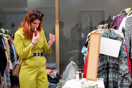 Woman Smelling a Perfume at the Market