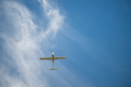 Mooloolaba Queensland, Australia - May 16th 2026 - Light Aircraft Flying Through Blue Sky with Wispy Clouds