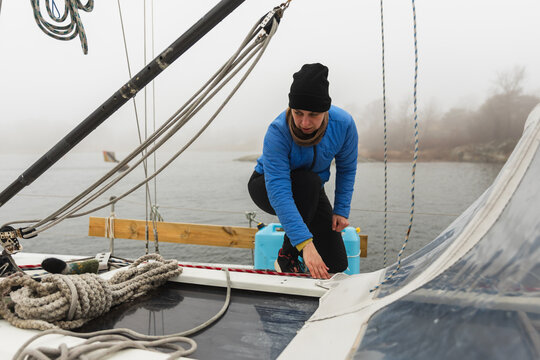 Female Sailor Organizing Ropes and Mast Rigging on Deck