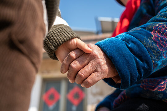 Hands of grandchild and grandparent