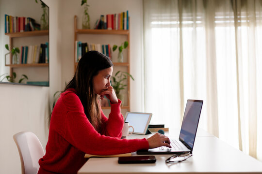 Concentrated Woman Working Intensely on Laptop