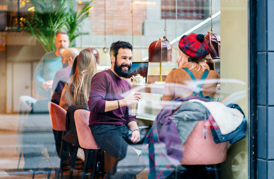 Friends enjoying conversation and drinks at a bar