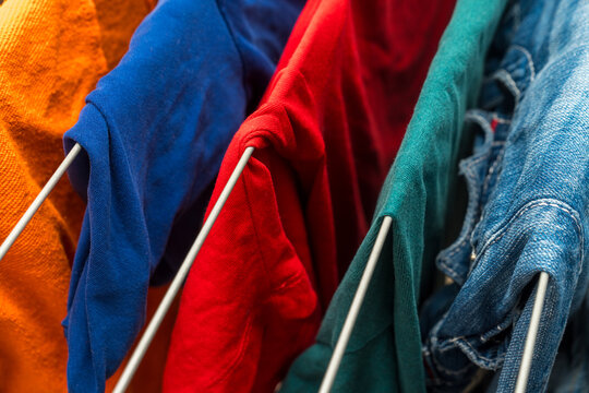 Colorful clothes hanging on drying rack