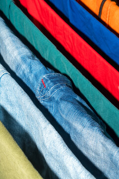 Colorful folded clothing and denim shirts