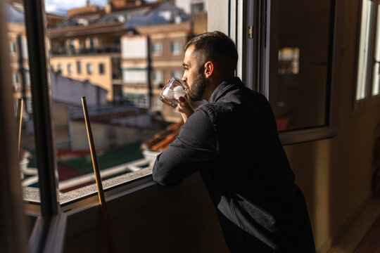 Man drinking during billiard game break at home