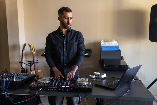 DJ mixing music in his home studio