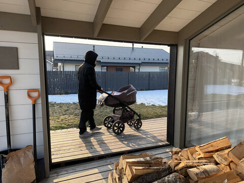 Pushing a stroller on a sunny day in winter