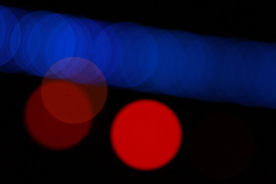 Abstract blue and red bokeh lights on dark background