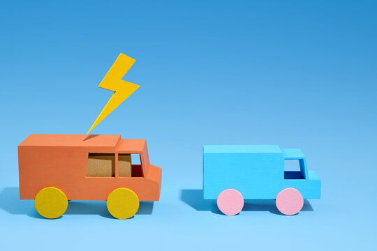 Toy trucks with lightning bolt symbol representing electric vehicle