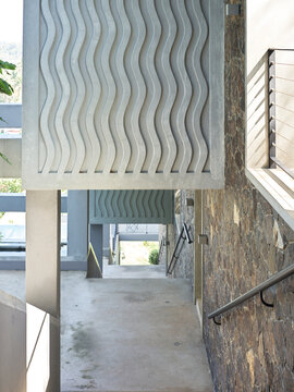 Modern Structure With Wavy Design and Stone Wall