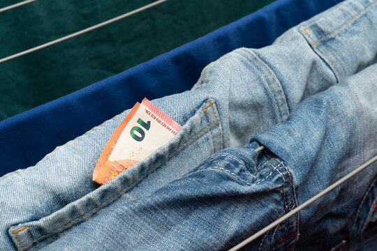 Euro banknote hidden in denim pocket on clothesline