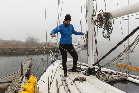 Female Sailor Organizing Ropes and Mast Rigging on Deck