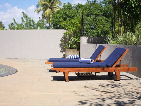 Luxury Lounge Chairs by Poolside in Tropical Setting