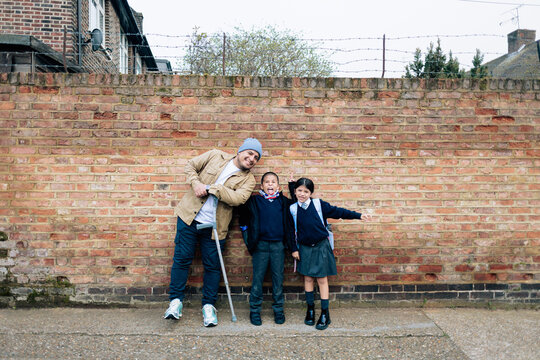 Parent with walking aid picking up children from school
