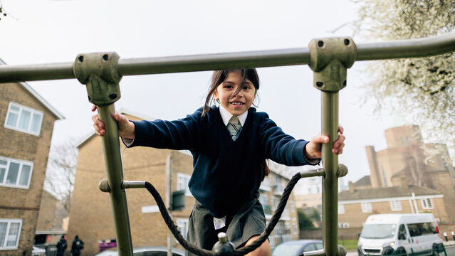 School girl playing on playground after class