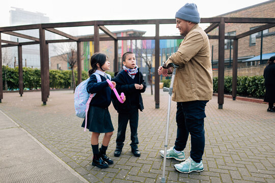 Father with disability picking up children from school