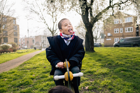 Child having fun making funny face in park