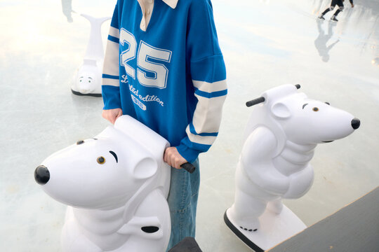 Woman with ice skates bear assistant