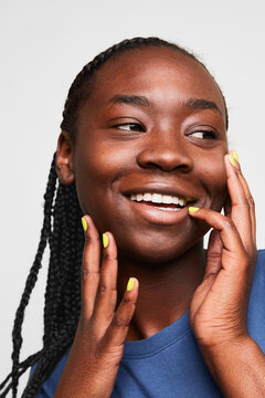 Smiling woman embracing beauty with vibrant manicure
