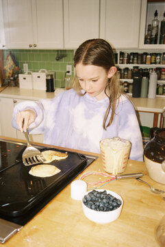 Portrait young girl making pancakes Kitchen 