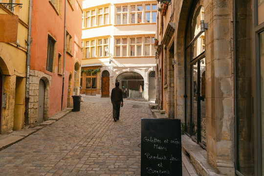 young man walking in a street in Vieux Lyon France 