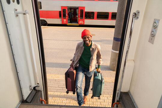 Man With Luggage Enters The Train 