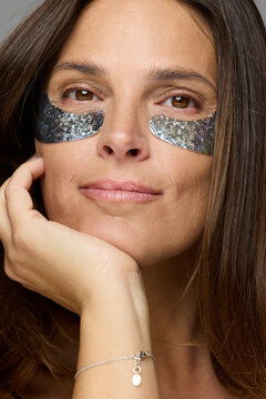 Woman With Black Eye Masks Looks at the Camera