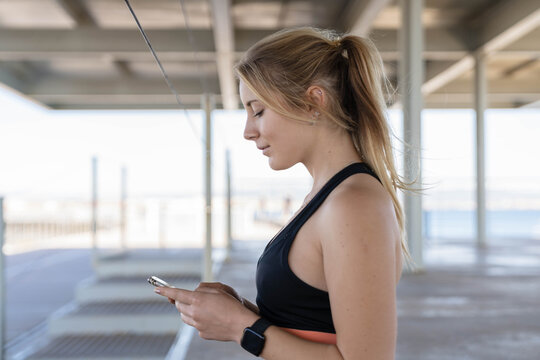 Athlete Using Phone At Covered Bridge.