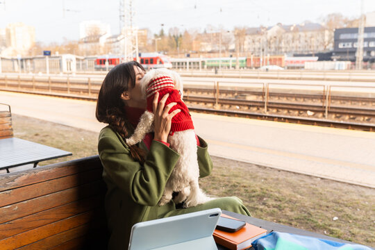 Woman Enjoys Time With Her Dog at Train Station i