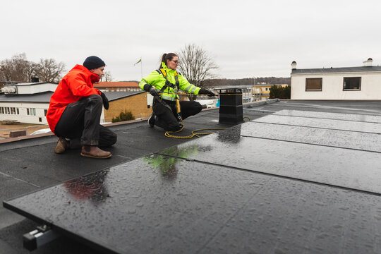Technician Explaining Solar Panel Inspection to Customer