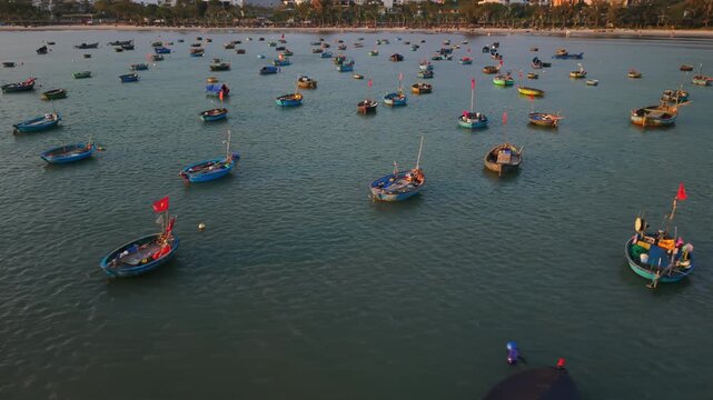 Vietnam, Da Nang Twilight Scene Of Da Nang Coracles With Red Flags Drifting Close To Shore, Asian Crew Visible On Round Boats Returning To Harbor Under Soft Evening Light