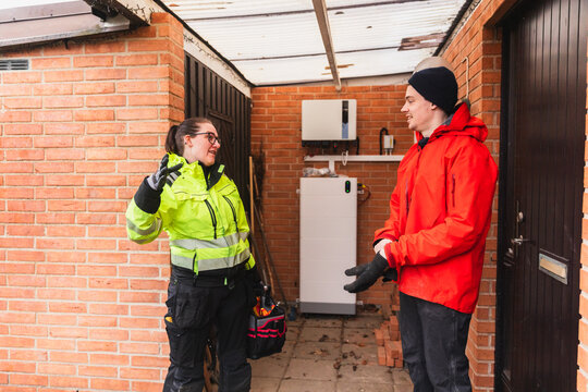 Technician and Homeowner Discussing Technical System Check