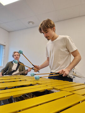 Young Male Musician Playing Marimba with Four Mallets in Music studio