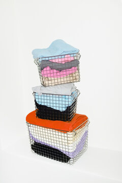 Silver wire baskets full of colourful fabrics and clothes with flash