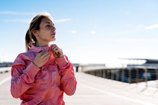 Athlete Zipping Up Jacket