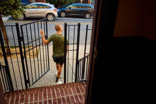 Man leaves his house, steps on the street