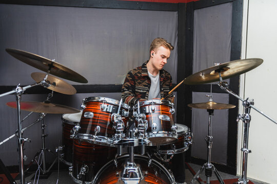 Professional Drummer Playing Acoustic Kit During Studio Session