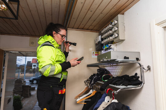 Technician Inspecting Electrical Fuse Box