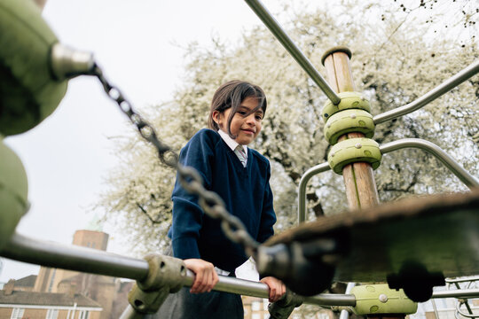 Student playing on school playground equipment outdoors