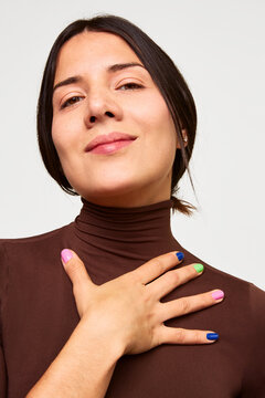 Woman with colorful manicure expressing self-care and beauty