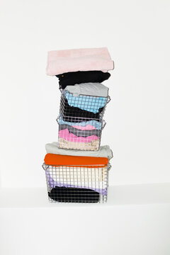 Silver wire baskets full of colourful fabrics and clothes with flash